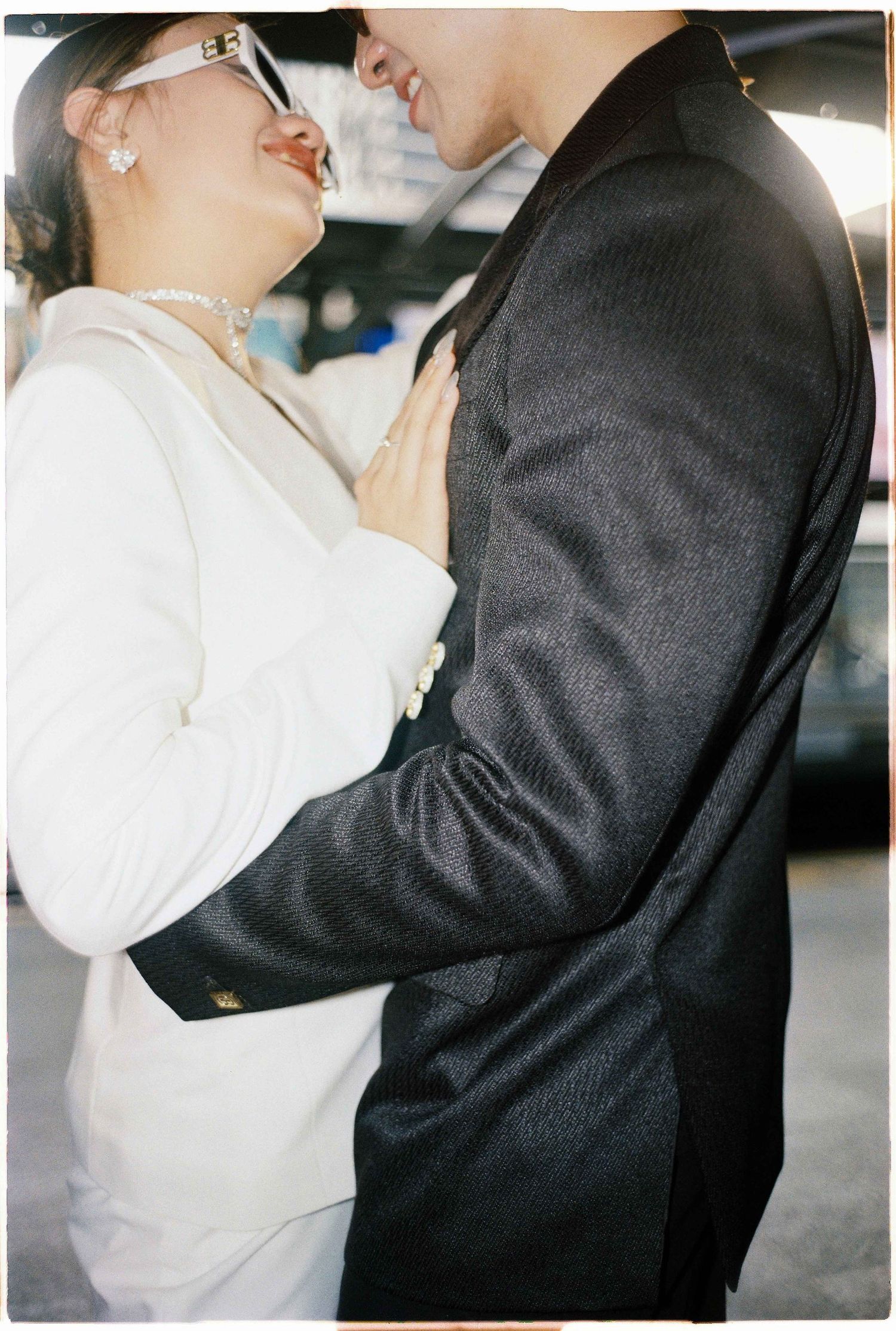 Saigon pre-wedding: close-up shot of two people in contrasting outfits sharing a laugh, by AnhVuWedding.