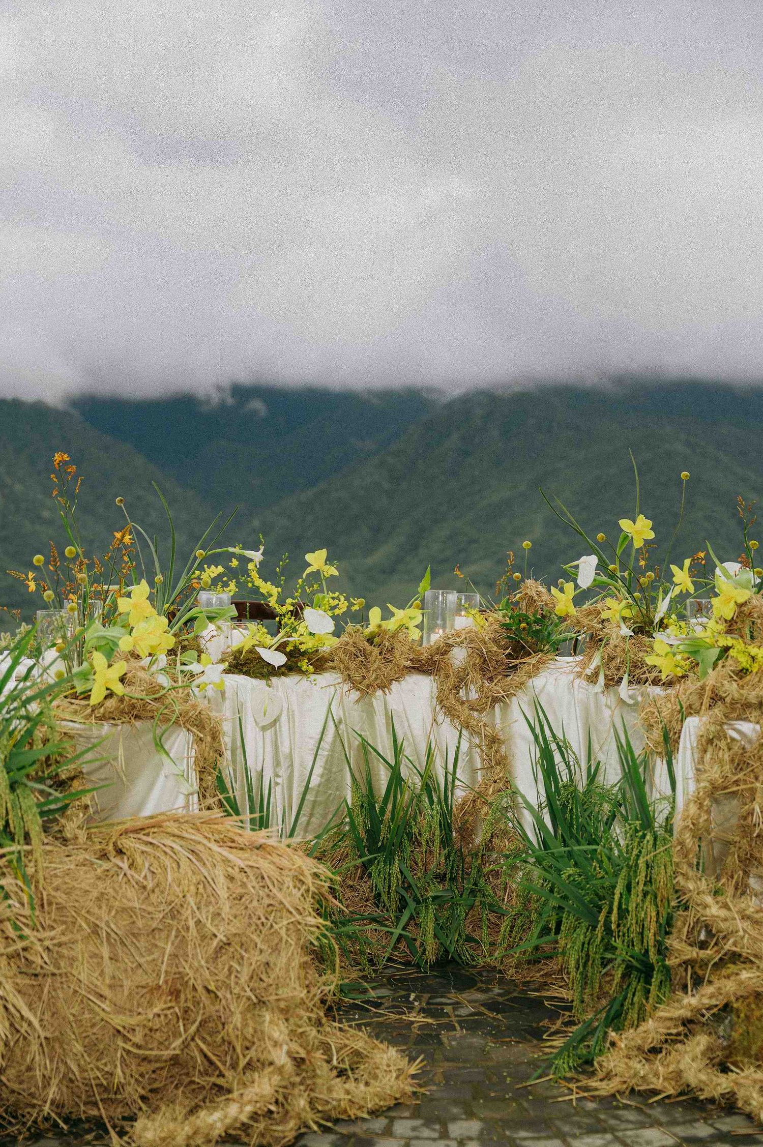 wedding: decorative garden arrangement with yellow flowers and hay bales, by AnhVuWedding.