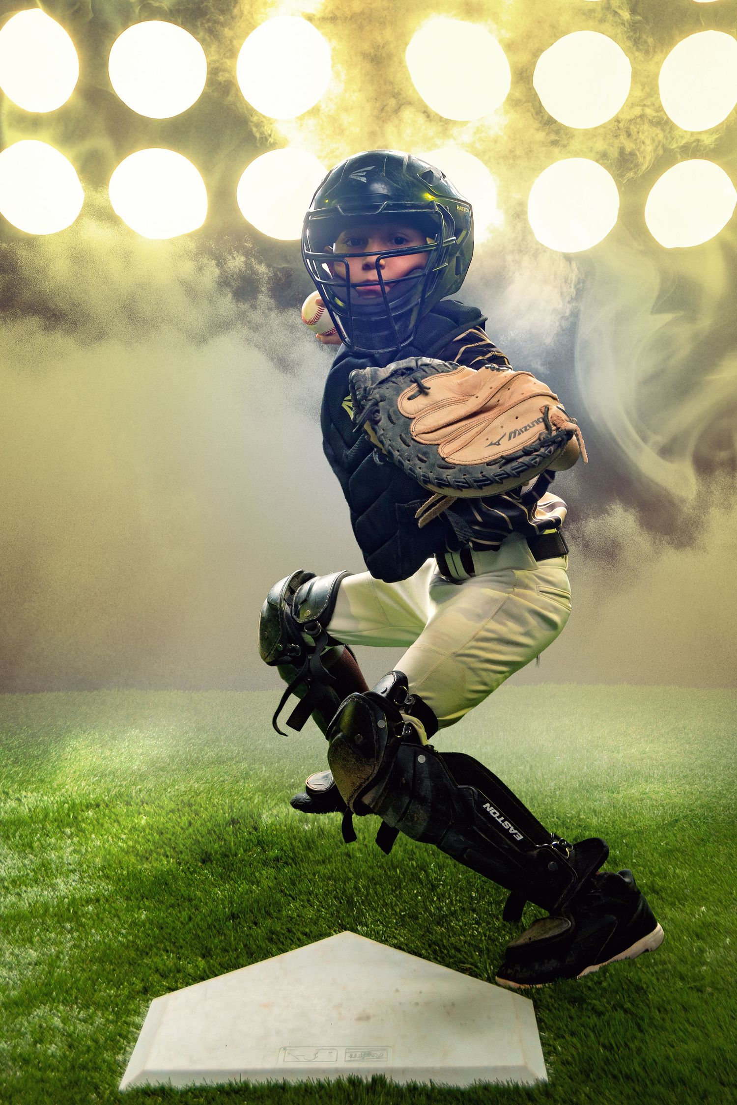 Young baseball catcher in full gear leaping at home plate under bright stadium lights with dramatic smoke effects.