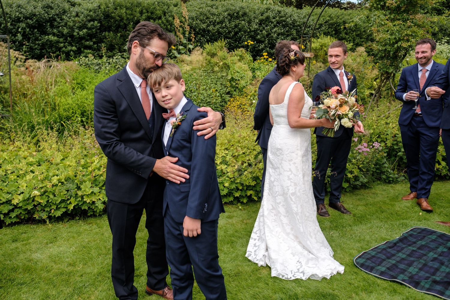 A joyous celebration unfolds on a sunny summer lawn with wedding attendees. Norfolk and Norwich wedding photographer.