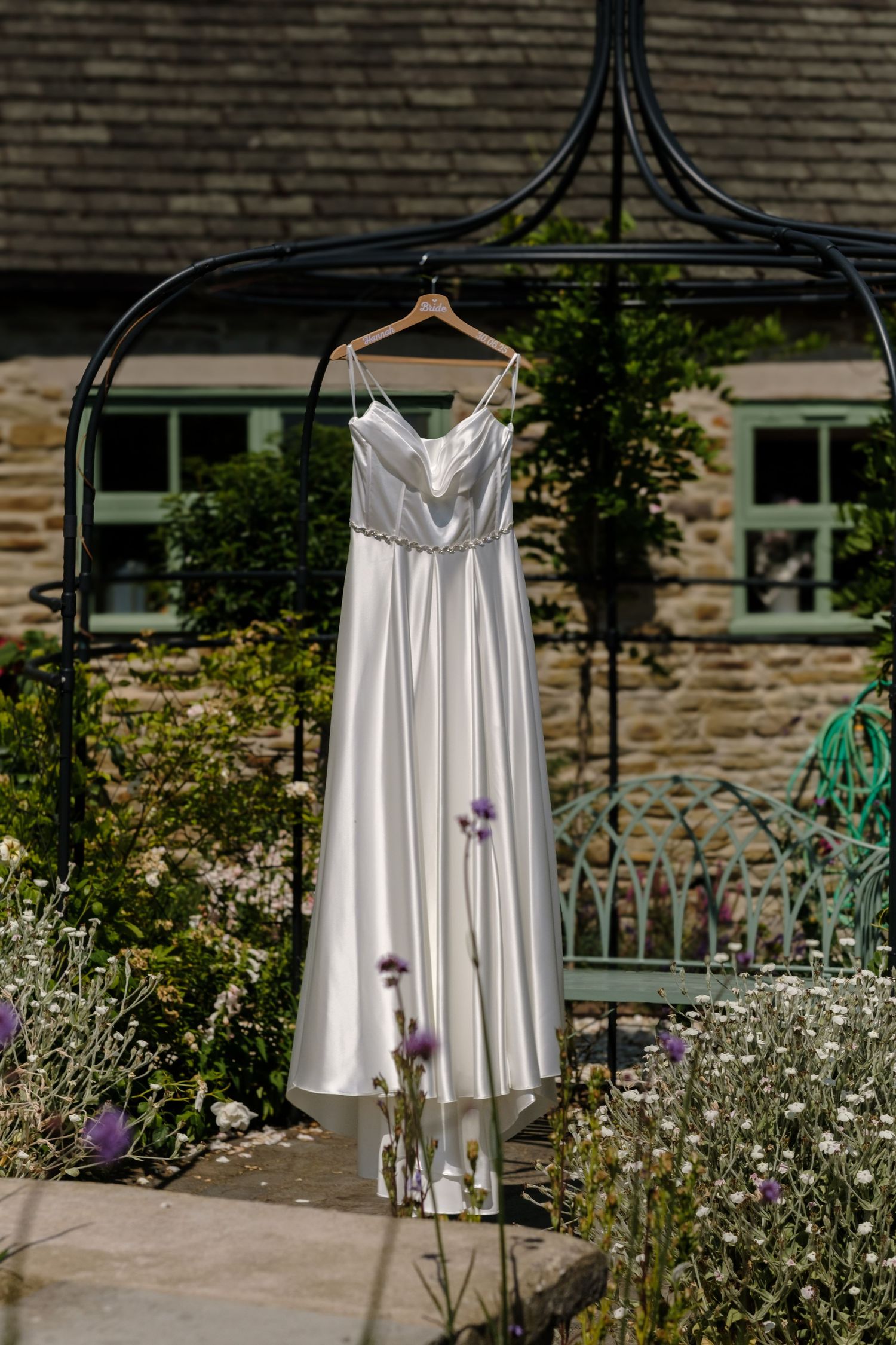 Wedding dress in garden by Norfolk and Norwich wedding photographer. Top 100 wedding photographer covering Norfolk, Suffolk, Cambridge.