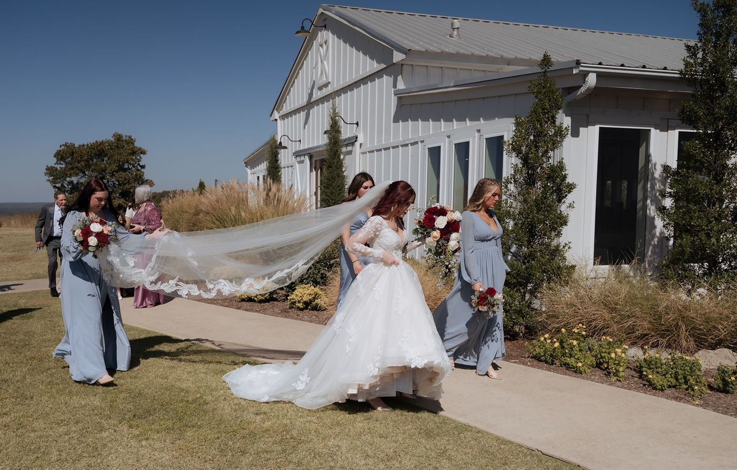 Bride and bridesmaid walking at Sapulpa wedding venue