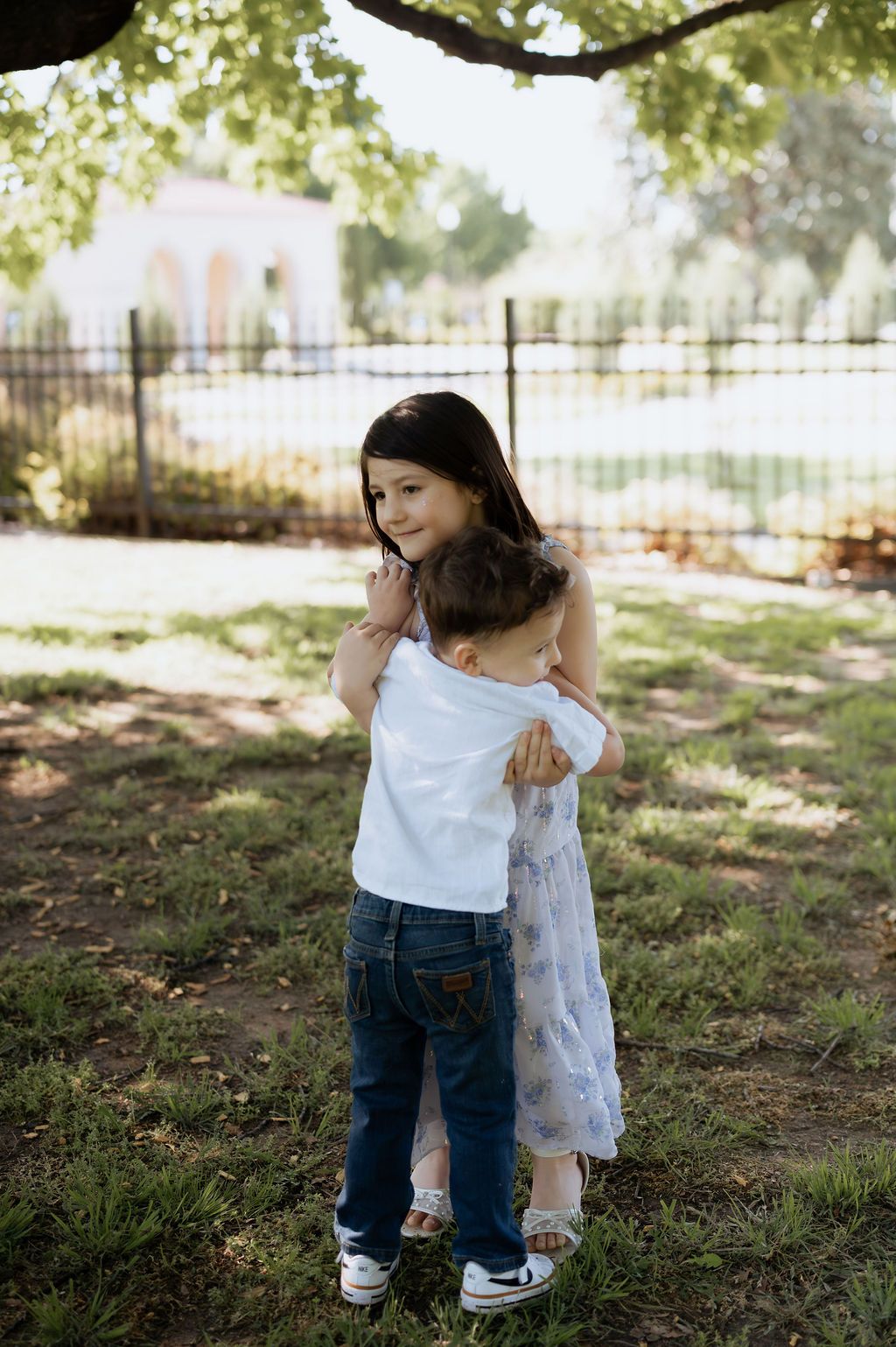 Emotional motherhood portrait featuring children outdoors in Tulsa at Woodward Park