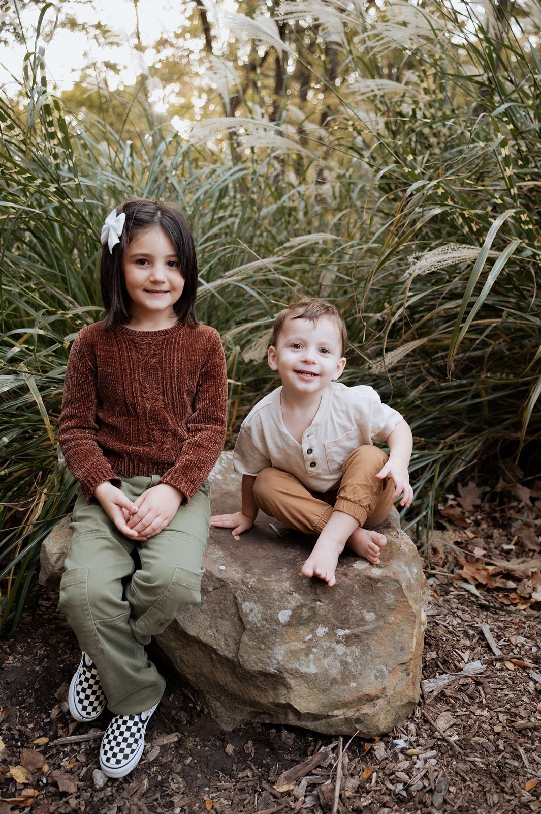 Sweet sibling portrait by Tulsa family photographer capturing playful children during an outdoor fall family session