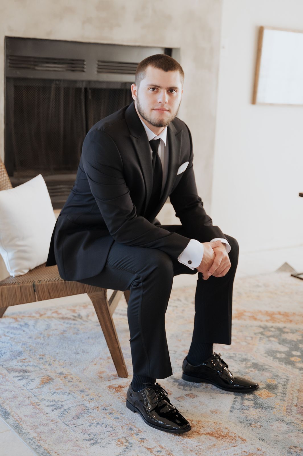 Portrait of groom in chair in groom suite