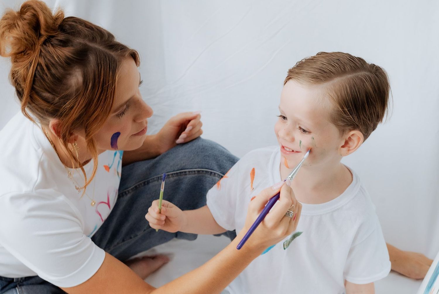 Mom painting son's face in mini photo session