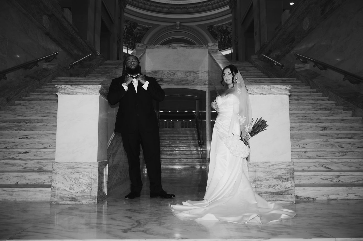 Bride and Groom in editorial pose on interior marble steps in Oklahoma State Capitol