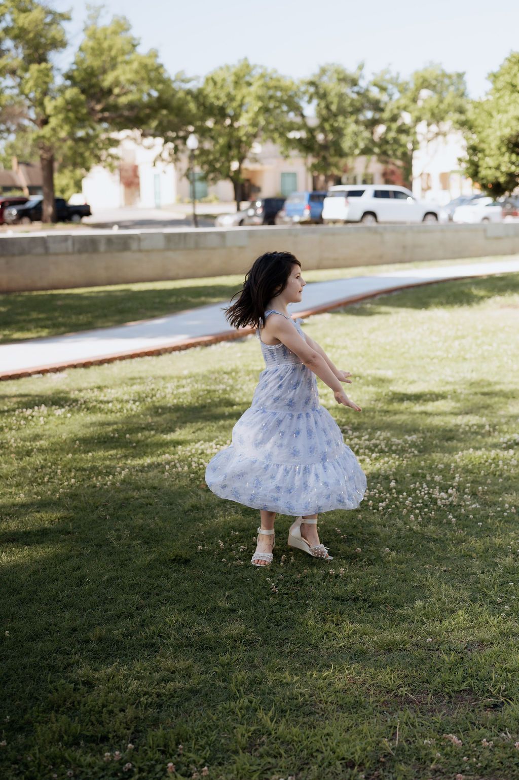 Free spirited girl spinning and having fun at Tulsa's Woodward Park