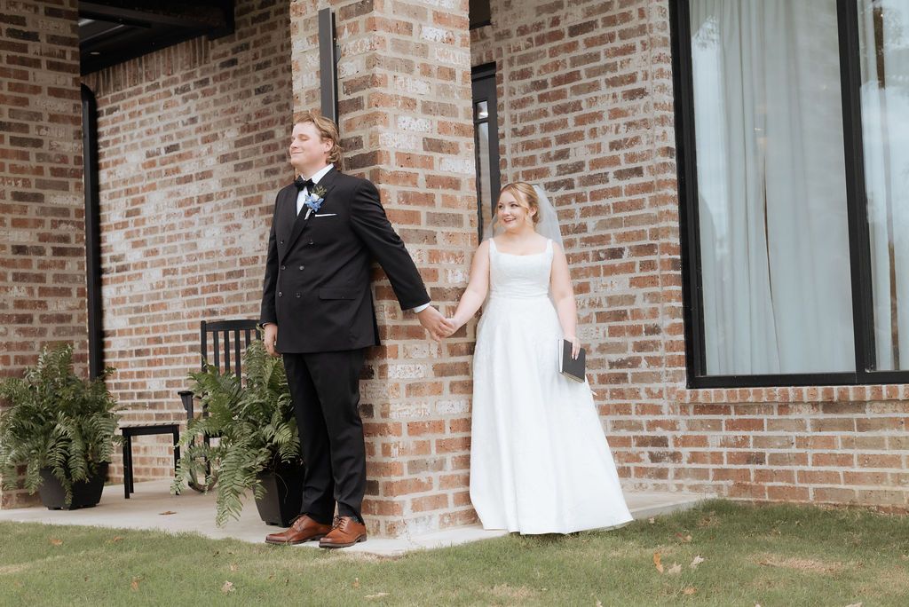 Couple having a first touch and reading vows at 1648 Venue