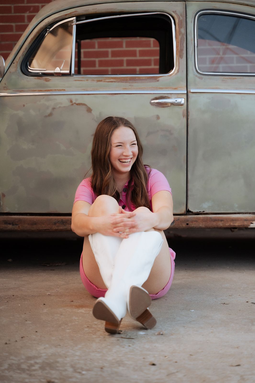 Girl laughing in front of old bug vehicle in broken arrow