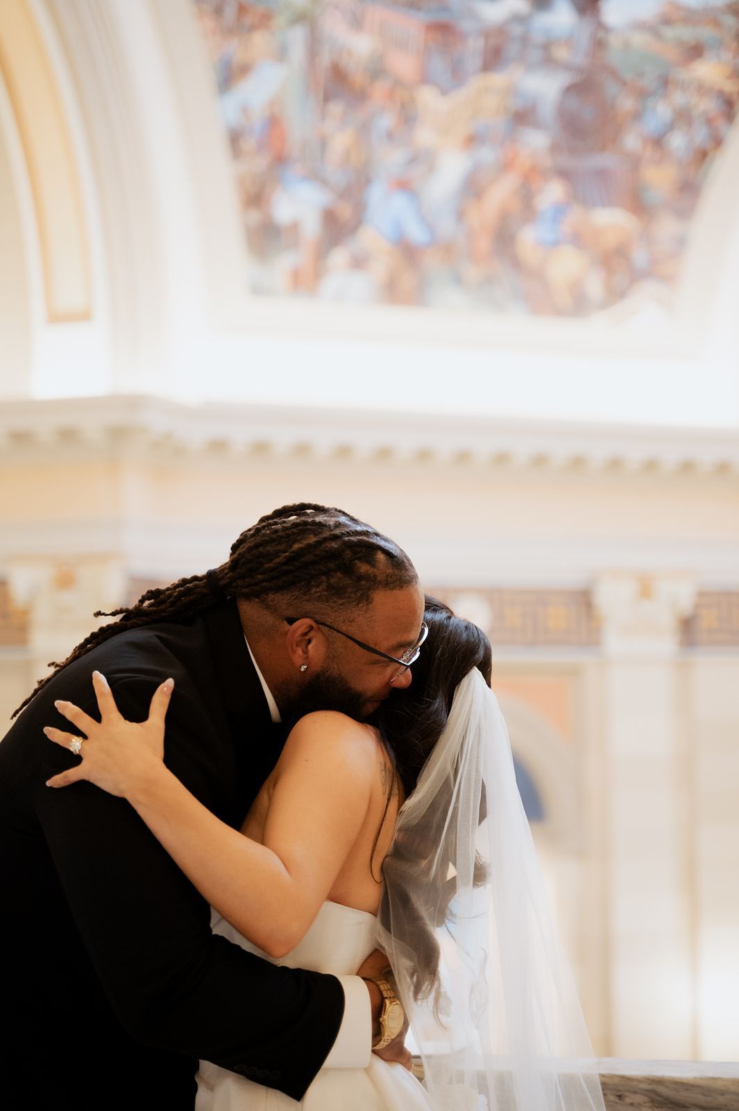 Couple's embrace after intimate elopement ceremony at Oklahoma State Capitol