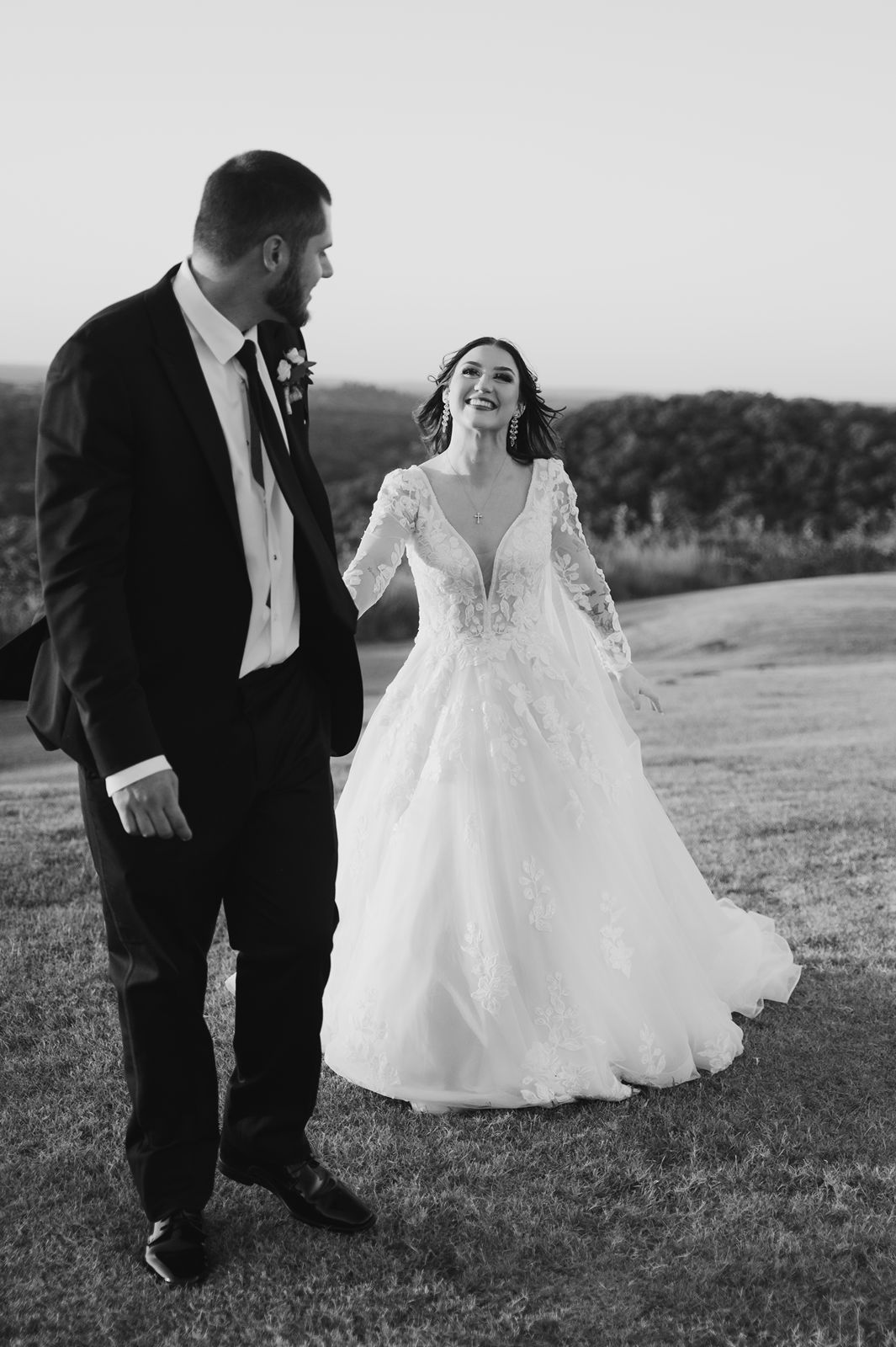 Bride and groom excited- view at hillside barn venue