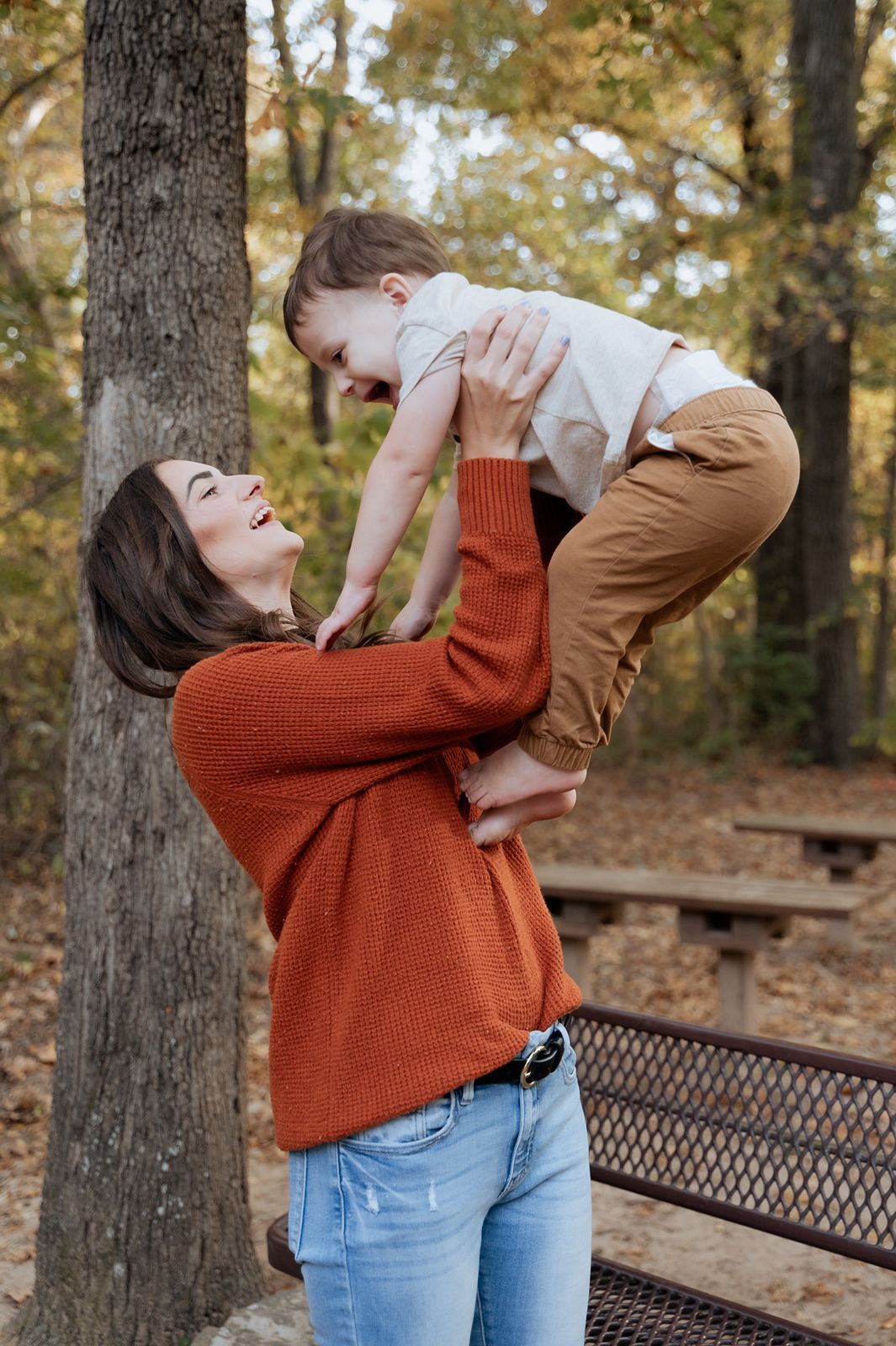 Tulsa family photography session with mom lifting toddler at Ray Harral Nature Center