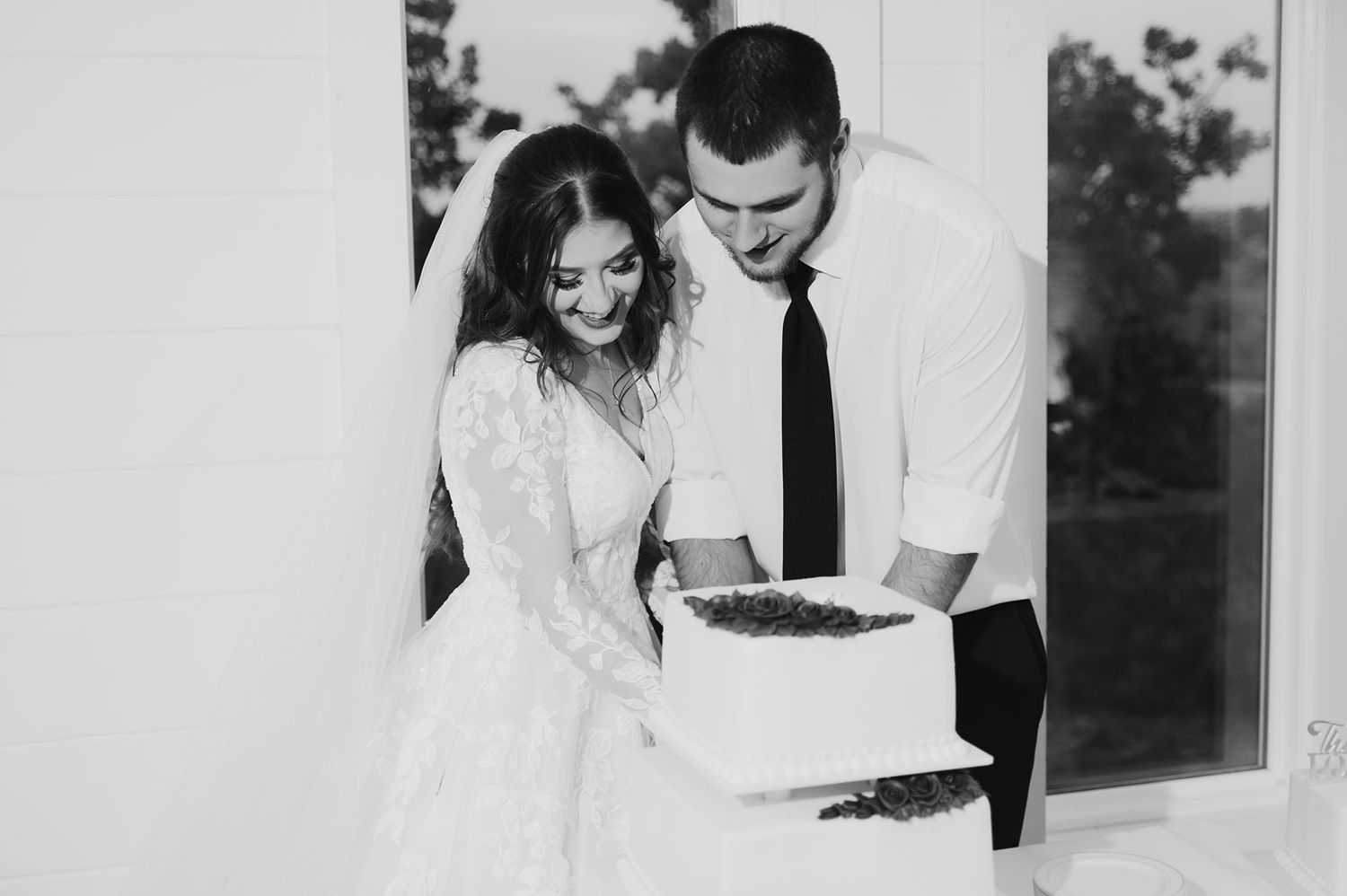 Bride and groom cutting into wedding cake
