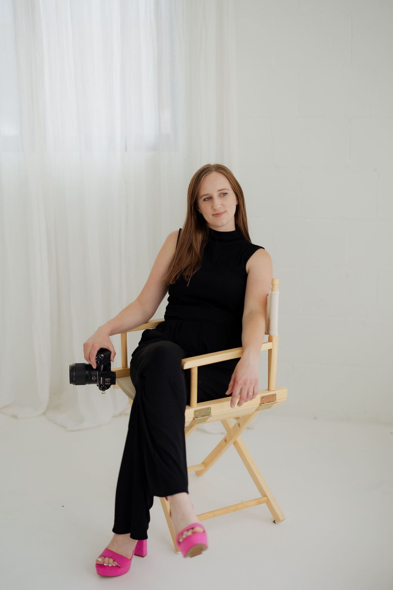 Tulsa Wedding Photographer Capturing Candid Photography sitting in a chair hold a camera