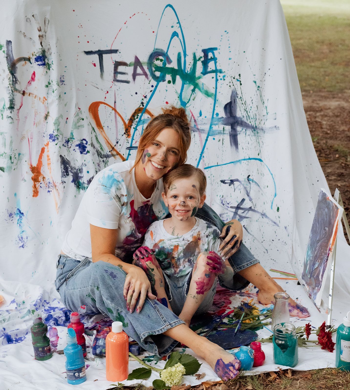 Mother and son smiling at the camera at end of the paint mini session