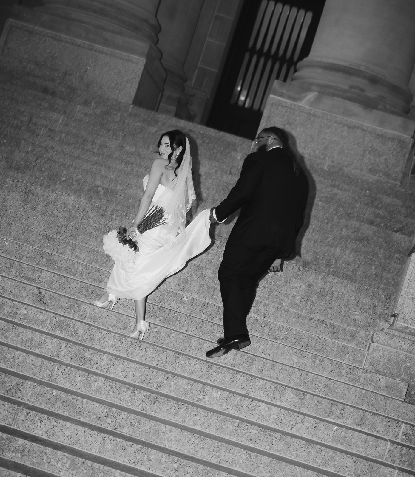 Groom helping bride up Capitol Steps