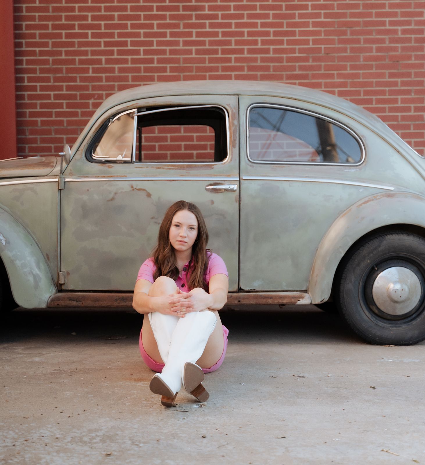 Girl posing by old run down bug in the Tulsa area