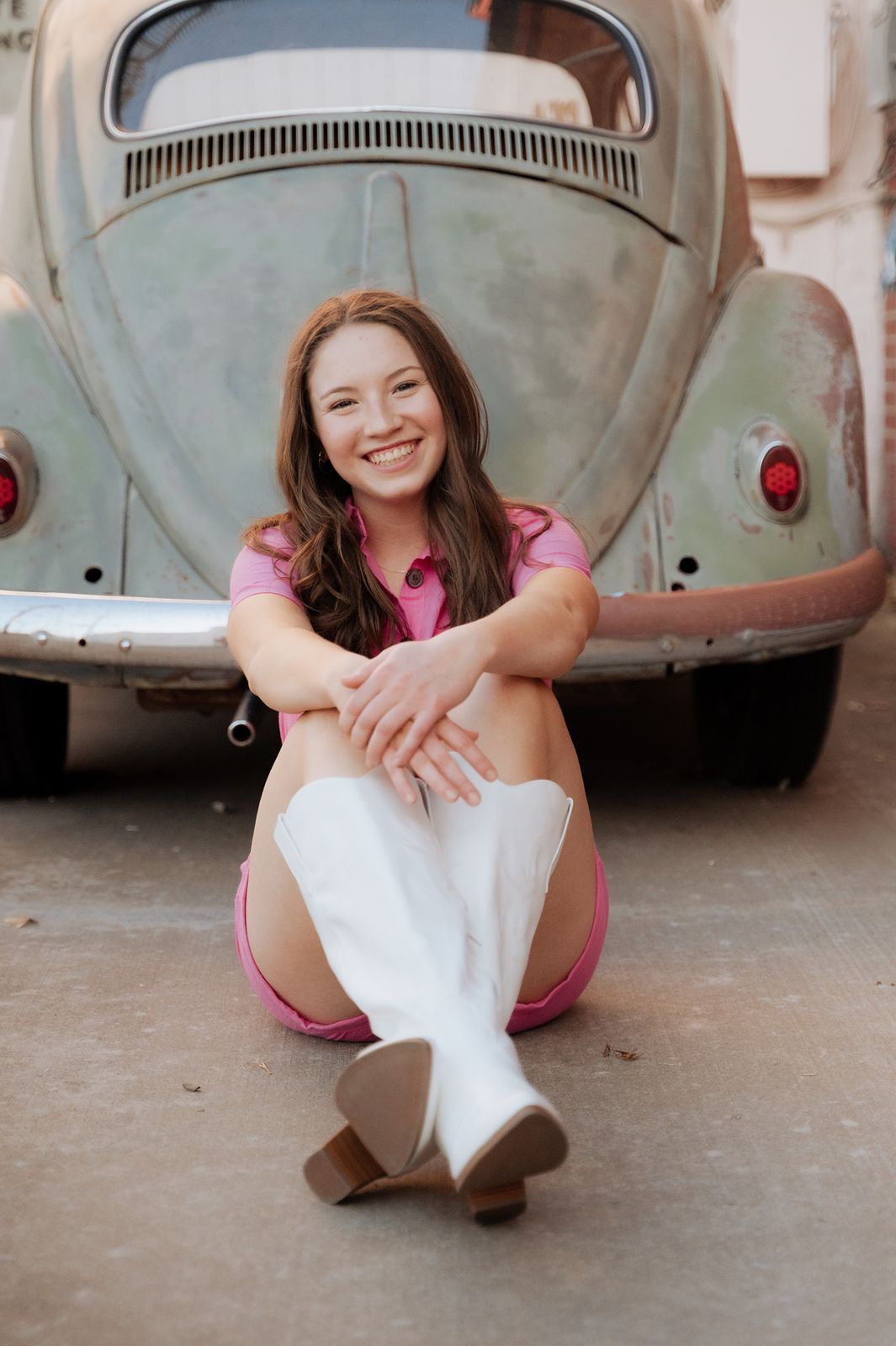 Girl smiling by old car in tulsa