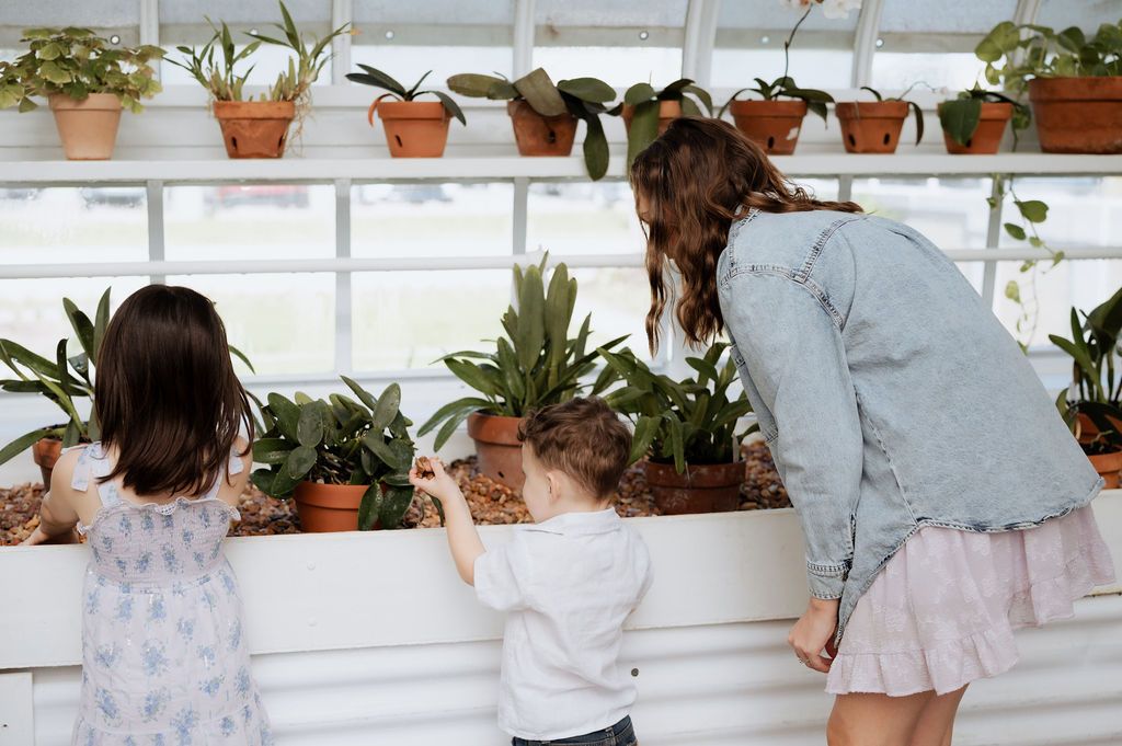 Tulsa family photography session with kids playing inside the Woodward Park conservatory
