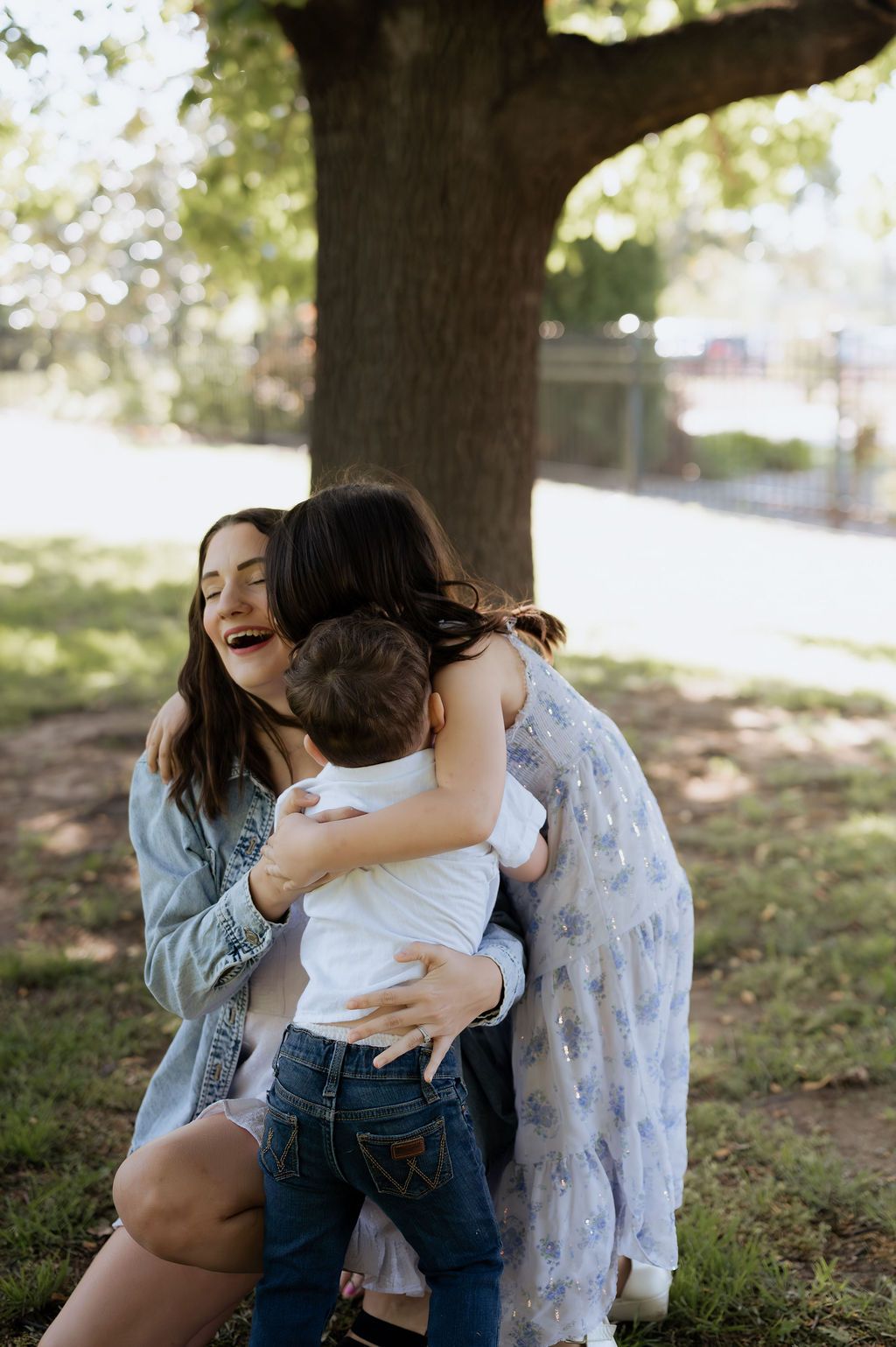 Candid family photo of mom holding her children at Woodward Park in Tulsa Oklahoma