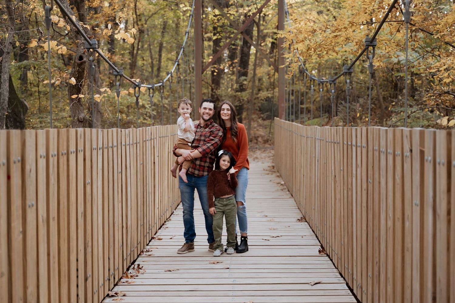 fall family portrait on a bridge at tulsa area park