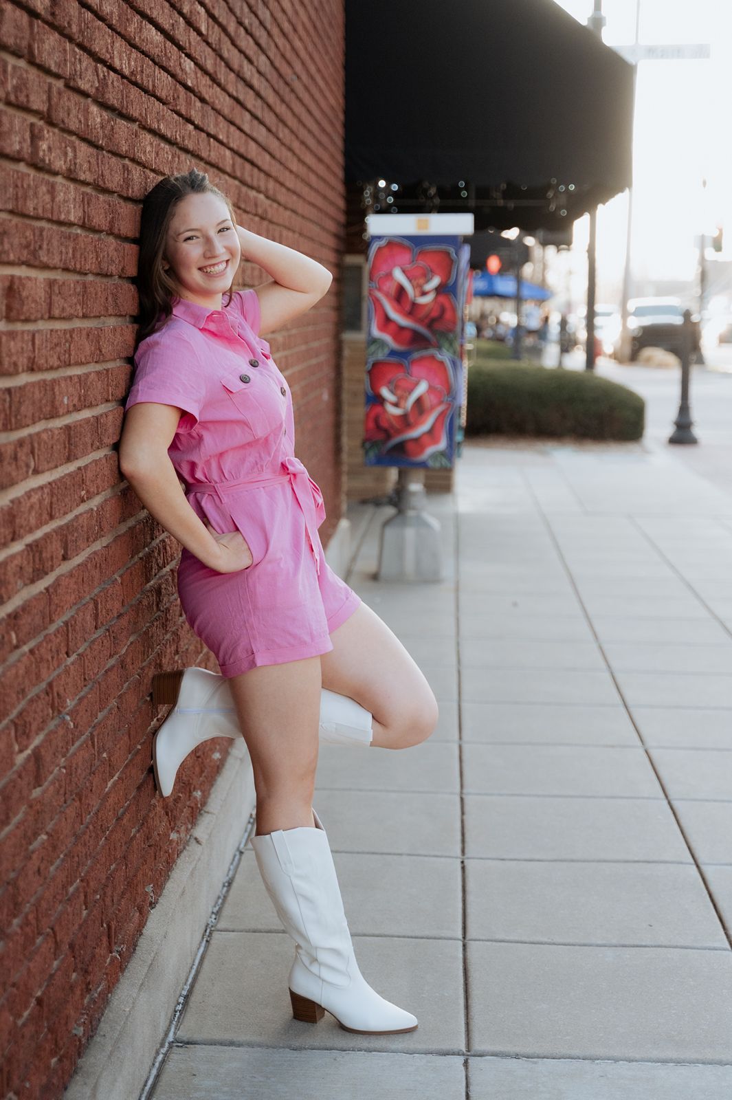 Girl posing along a brick wall for a dynamic image