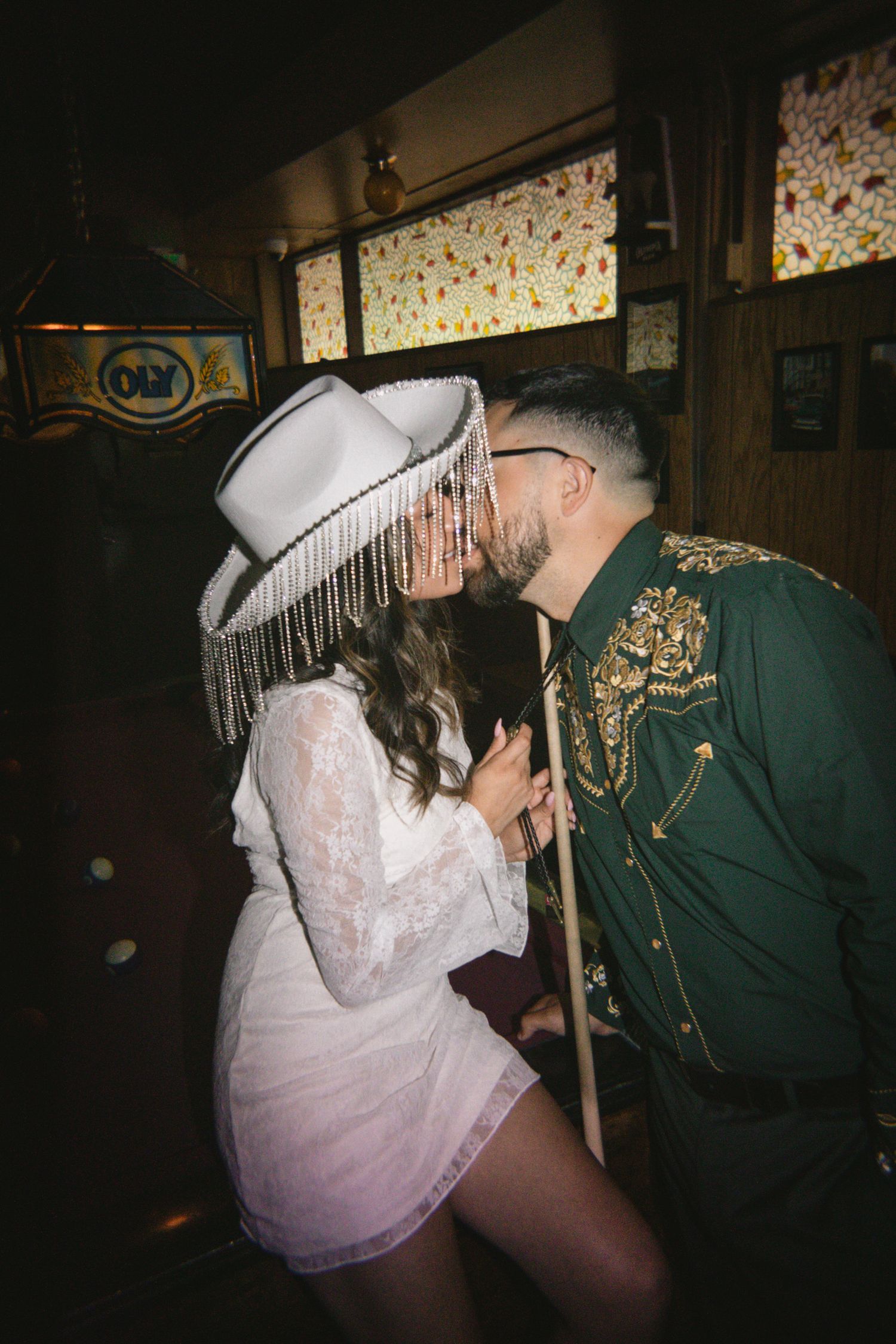 Couples photo shoot at Sandy Hut bar in Southeast Portland, Oregon. Mexican wedding, cowgirl aesthetic, cowboy hat, western theme, dive bar.