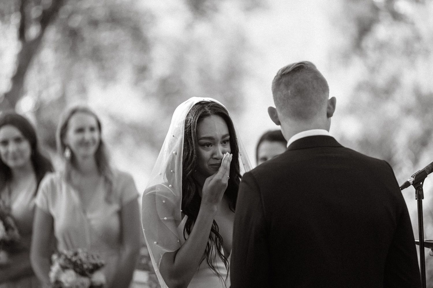 tearful bride during wedding vows. Interracial couple. Portland Oregon wedding. Emotional.