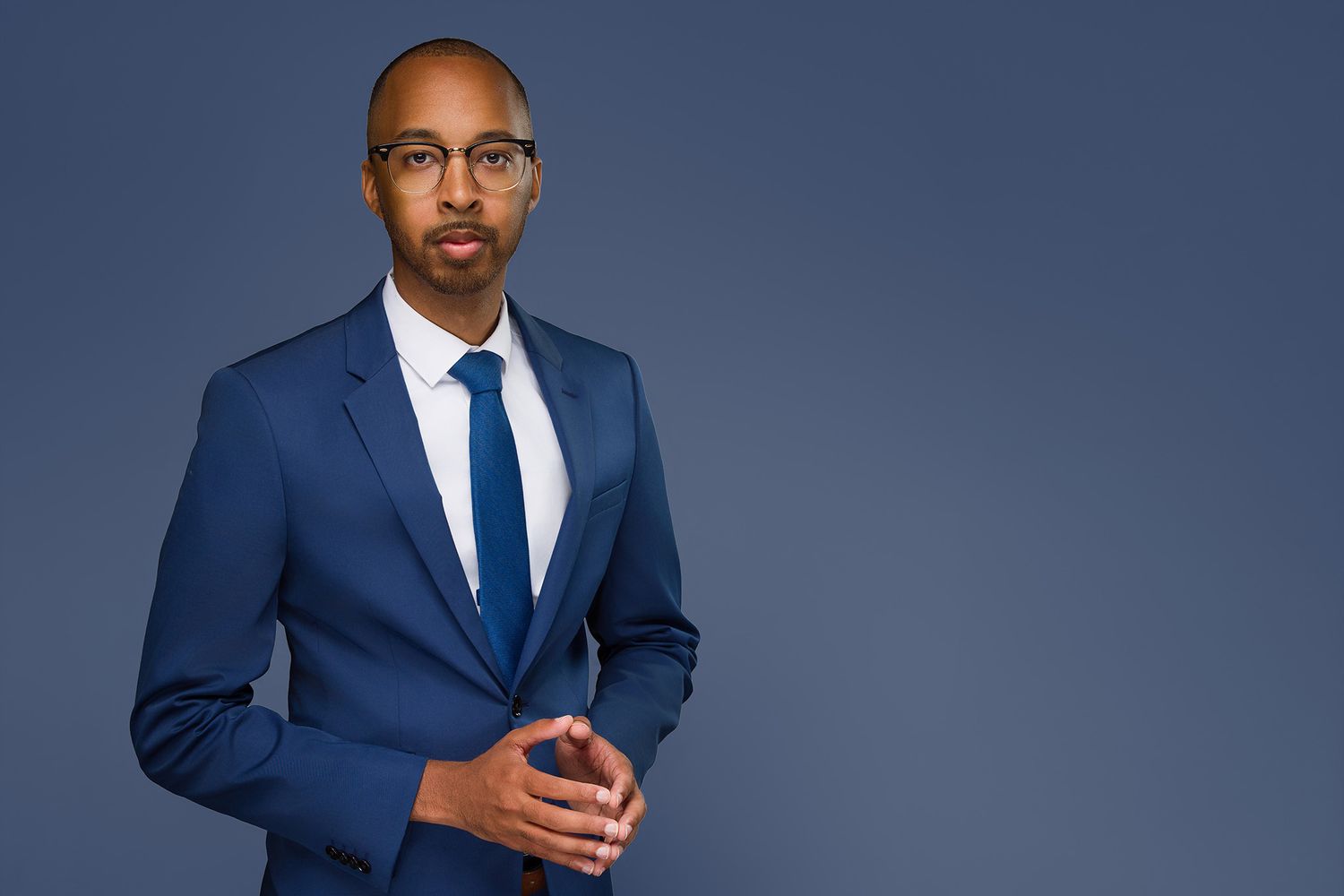 Real estate agent headshot with a dynamic expression, captured against a clean, light backdrop for their marketing materials.