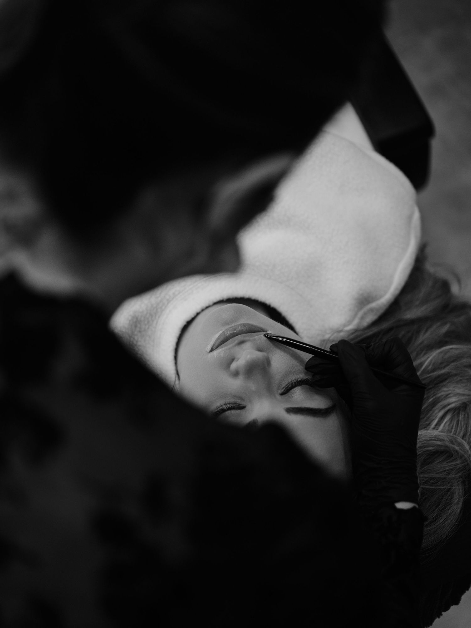 A dramatic black and white close-up portrait showing intimate eye contact in an artistic composition.