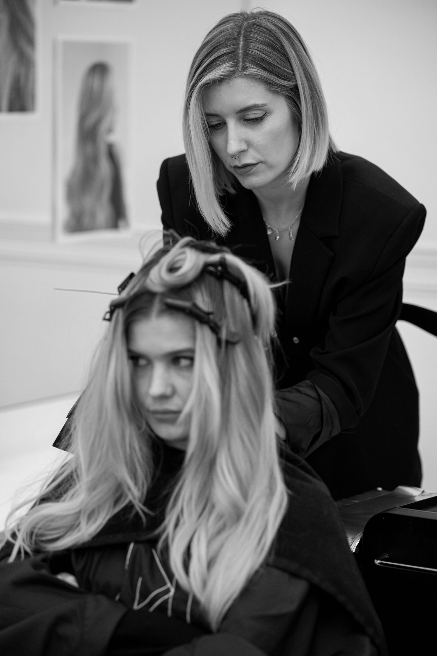 Series of black and white photos capturing a professional hair styling appointment.