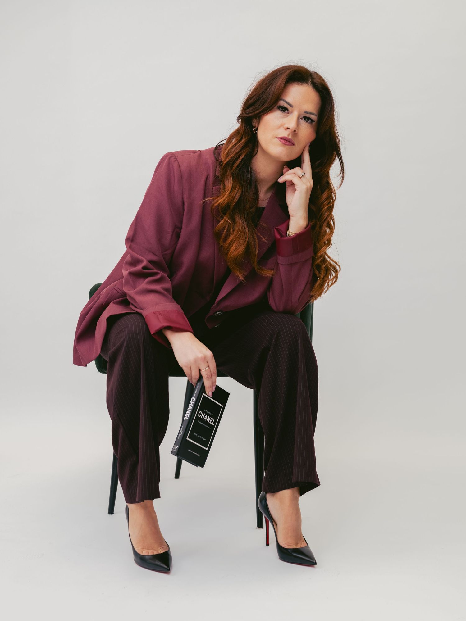 Professional fashion photo series showing a model in burgundy blazer and black pants posing on white background.