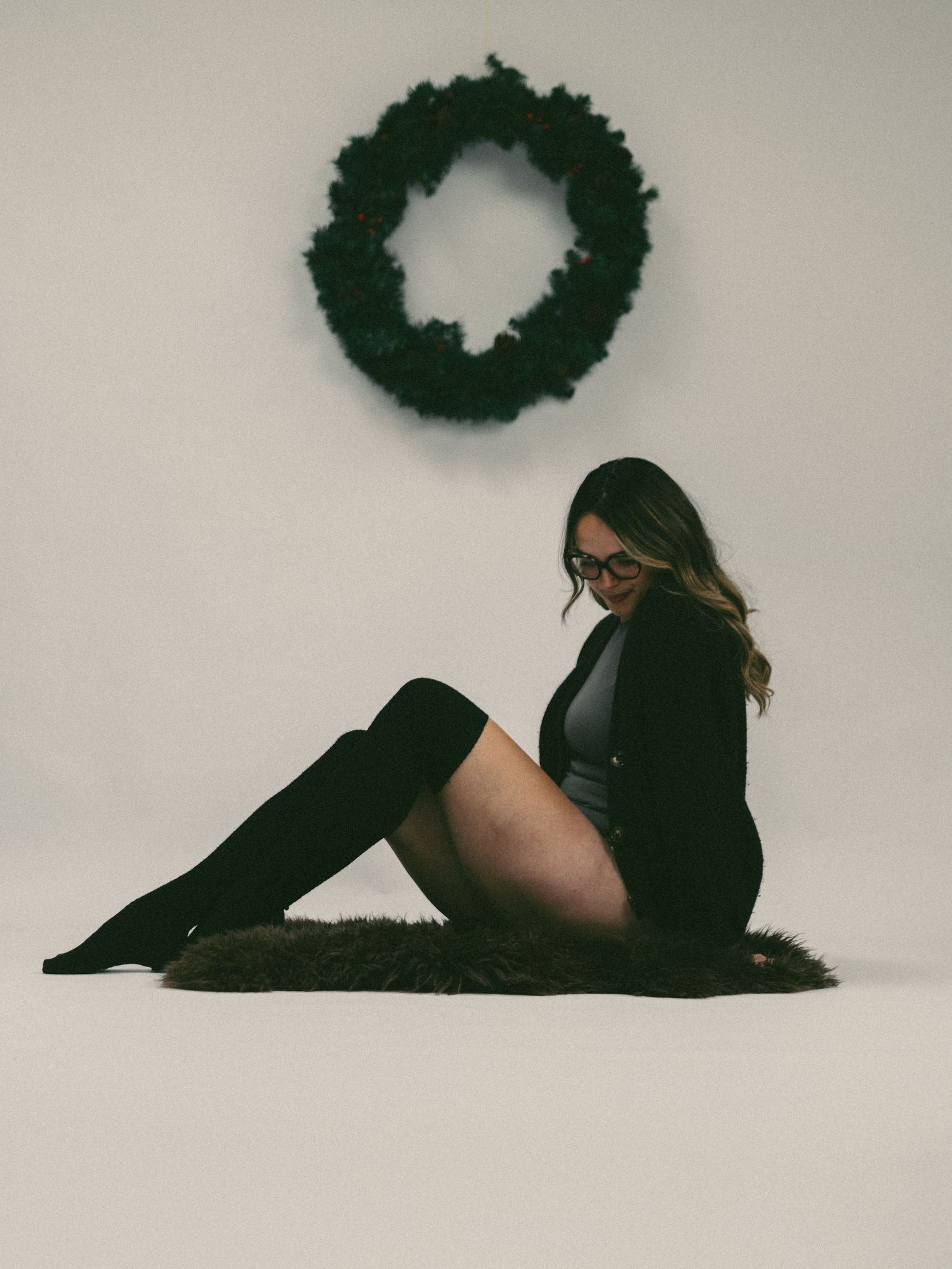 A series of minimalist black and white photos showing a figure in various reclining poses against a plain background.