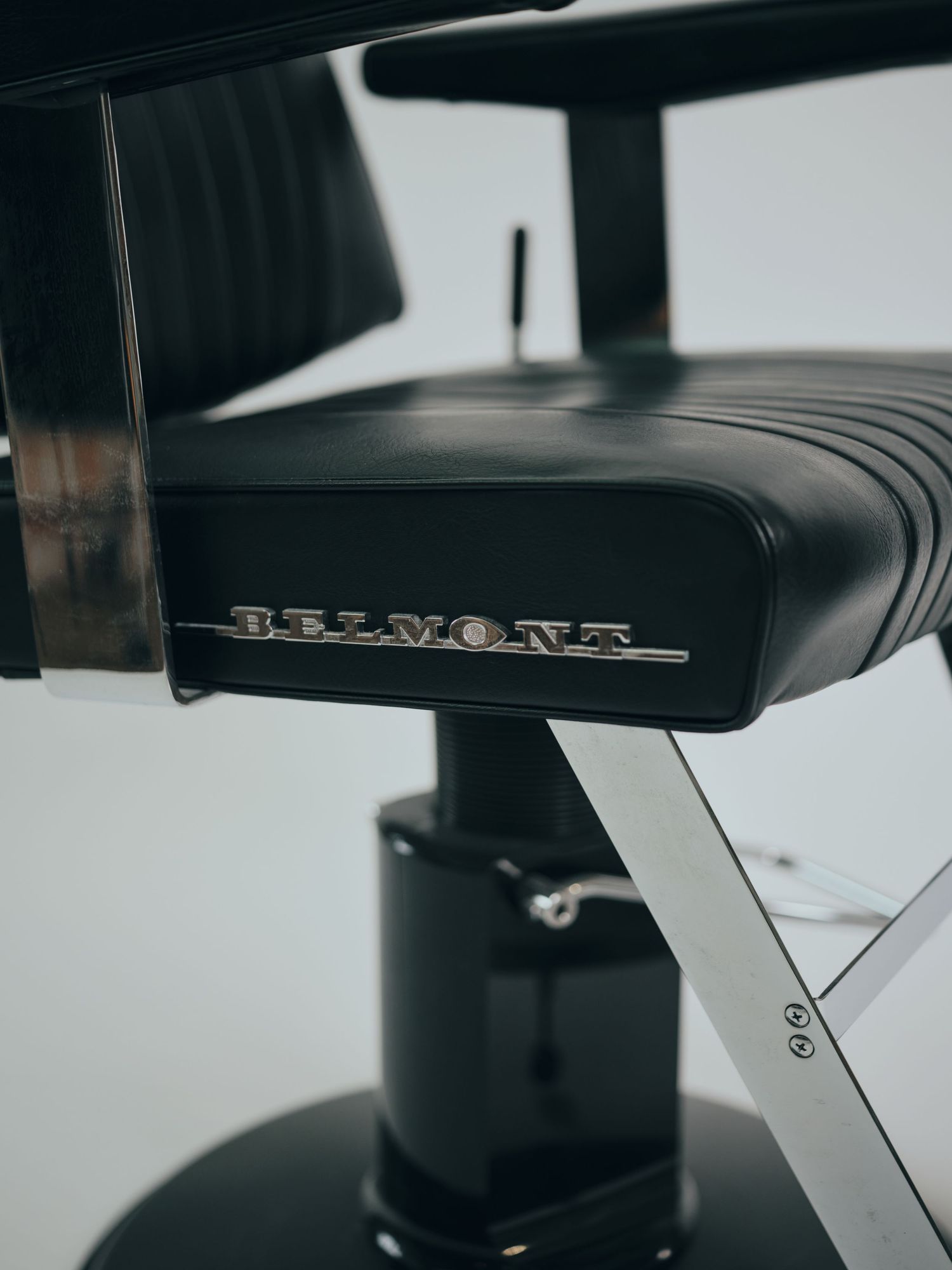 Close-up detail shots of a black leather car seat showing stitching patterns and surface texture in monochromatic style.