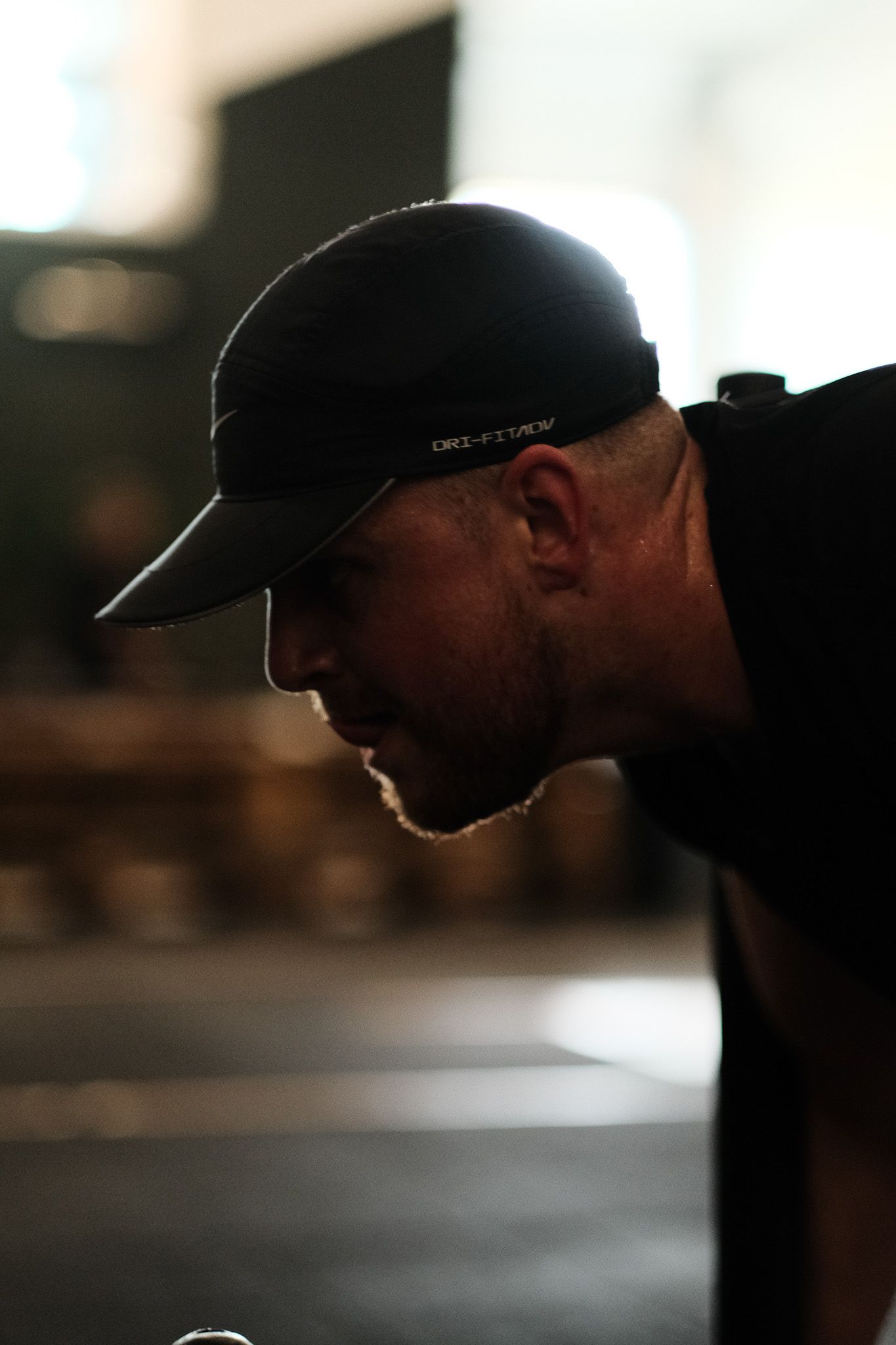 Silhouetted profile against a blurred bright background.