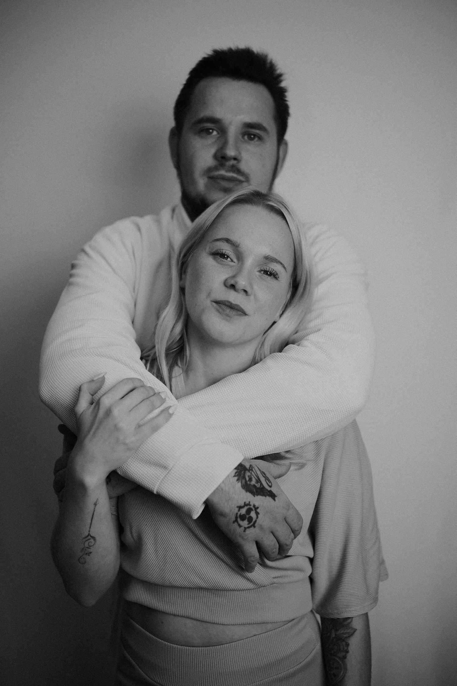 Black and white portrait series of couple in intimate poses.