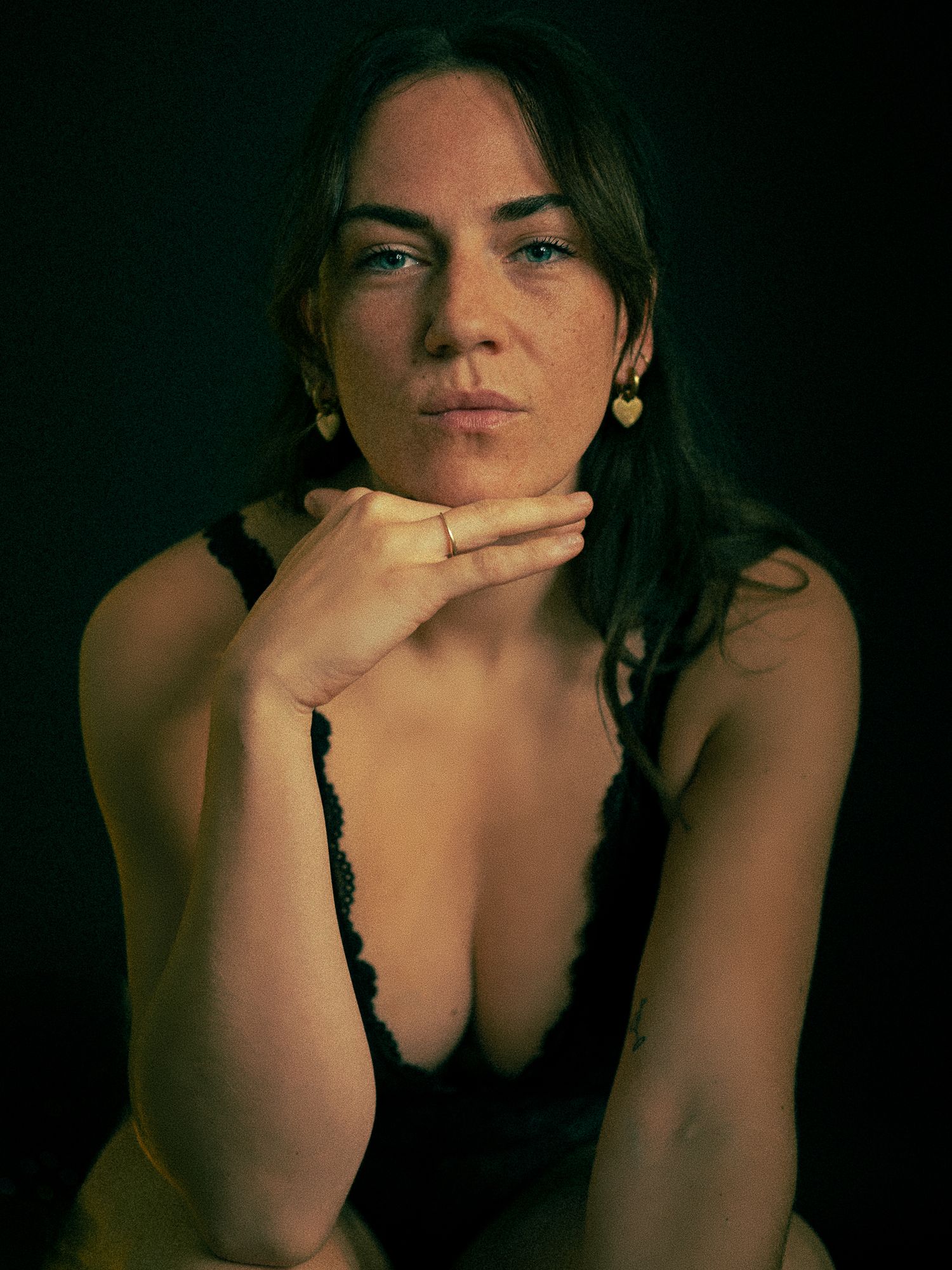 Moody low-light portrait series with dramatic shadows and intimate poses.