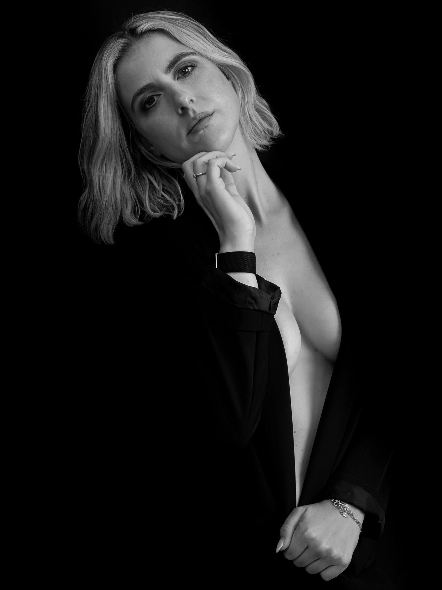 Dramatic black and white portrait series with artistic lighting and poses.
