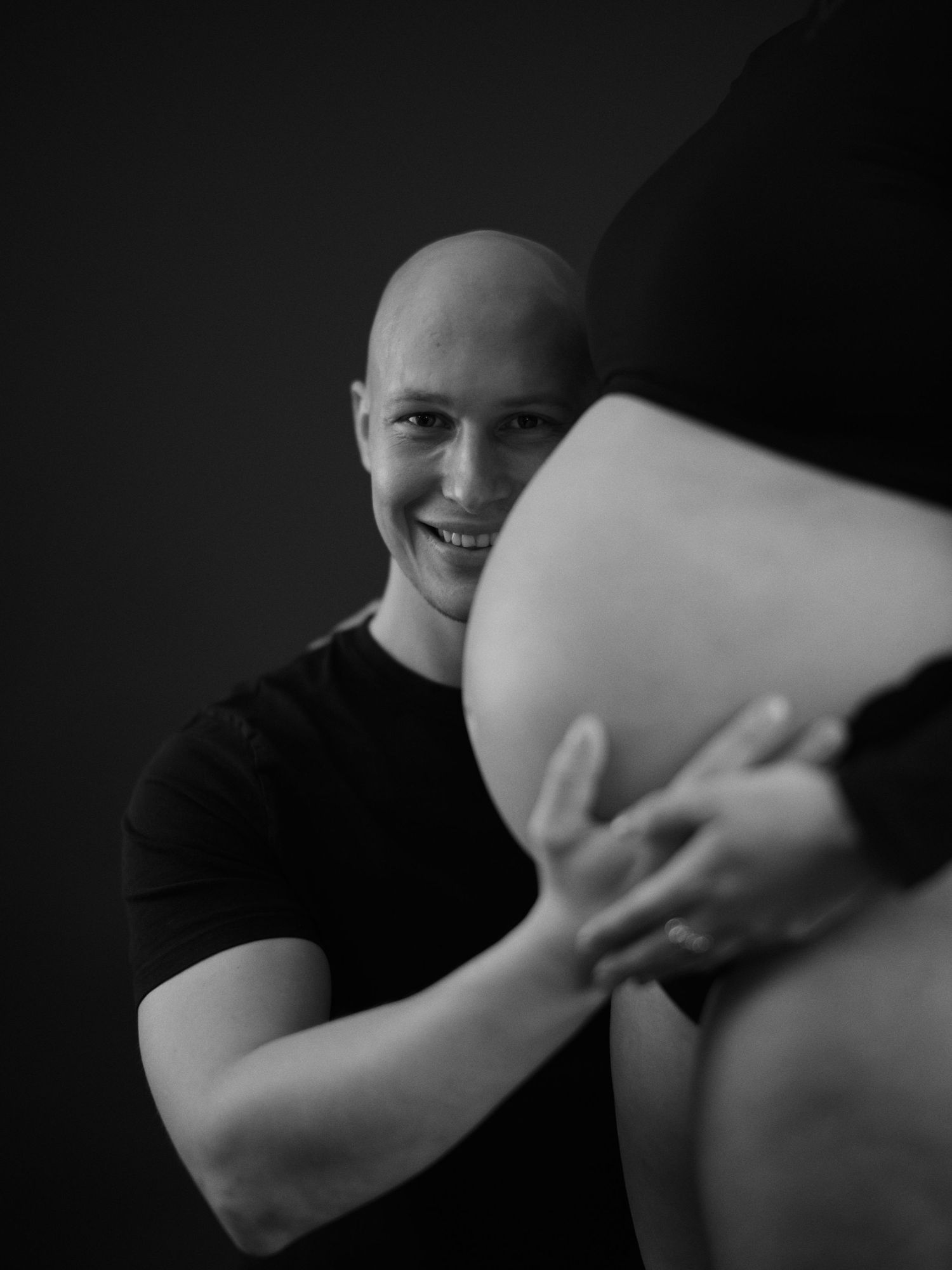 A dramatic black and white sequence showing hands in motion against a dark background.