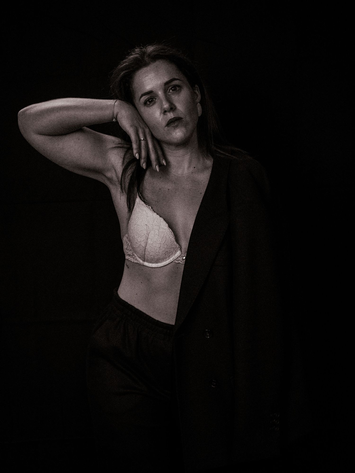 Dramatic black and white artistic portrait series showing expressive poses against dark background.