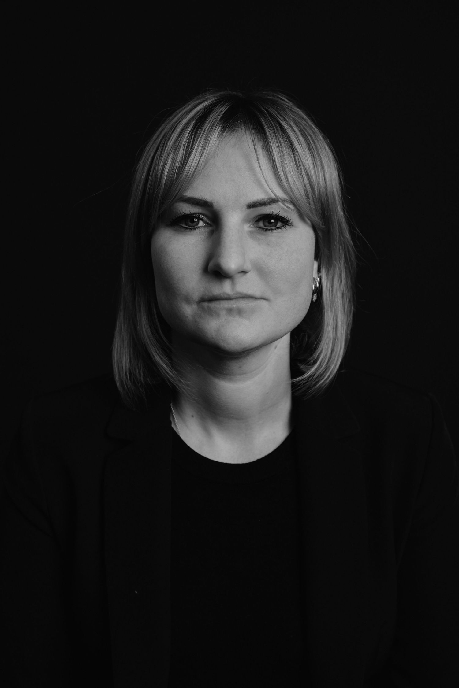 A series of black and white portraits showing different angles of a person with blonde hair against a dark background.