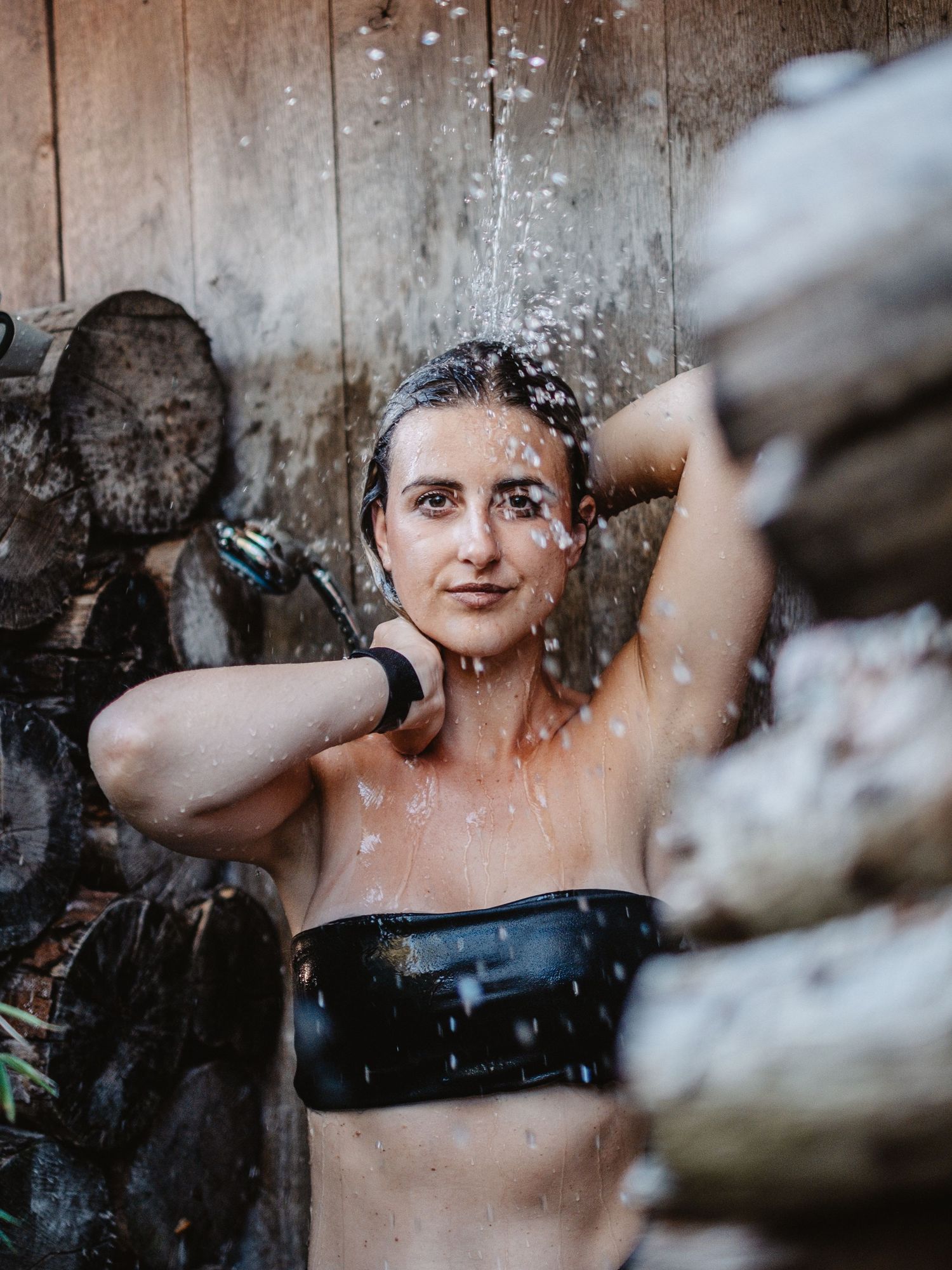 A sequence of artistic portraits showing someone taking a shower with water droplets and dramatic lighting effects.