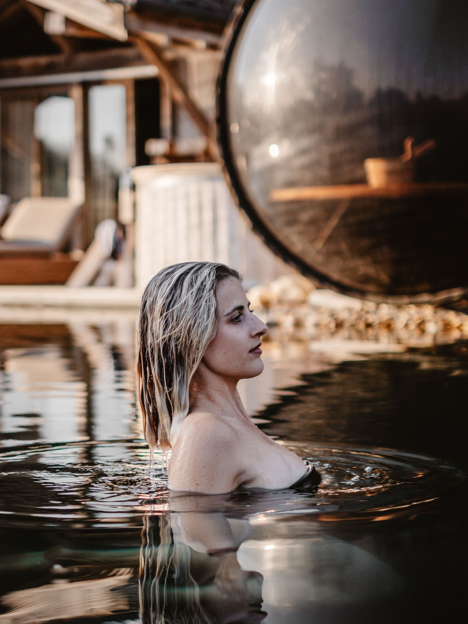 Dramatic pool portrait with dark water reflections at dusk.