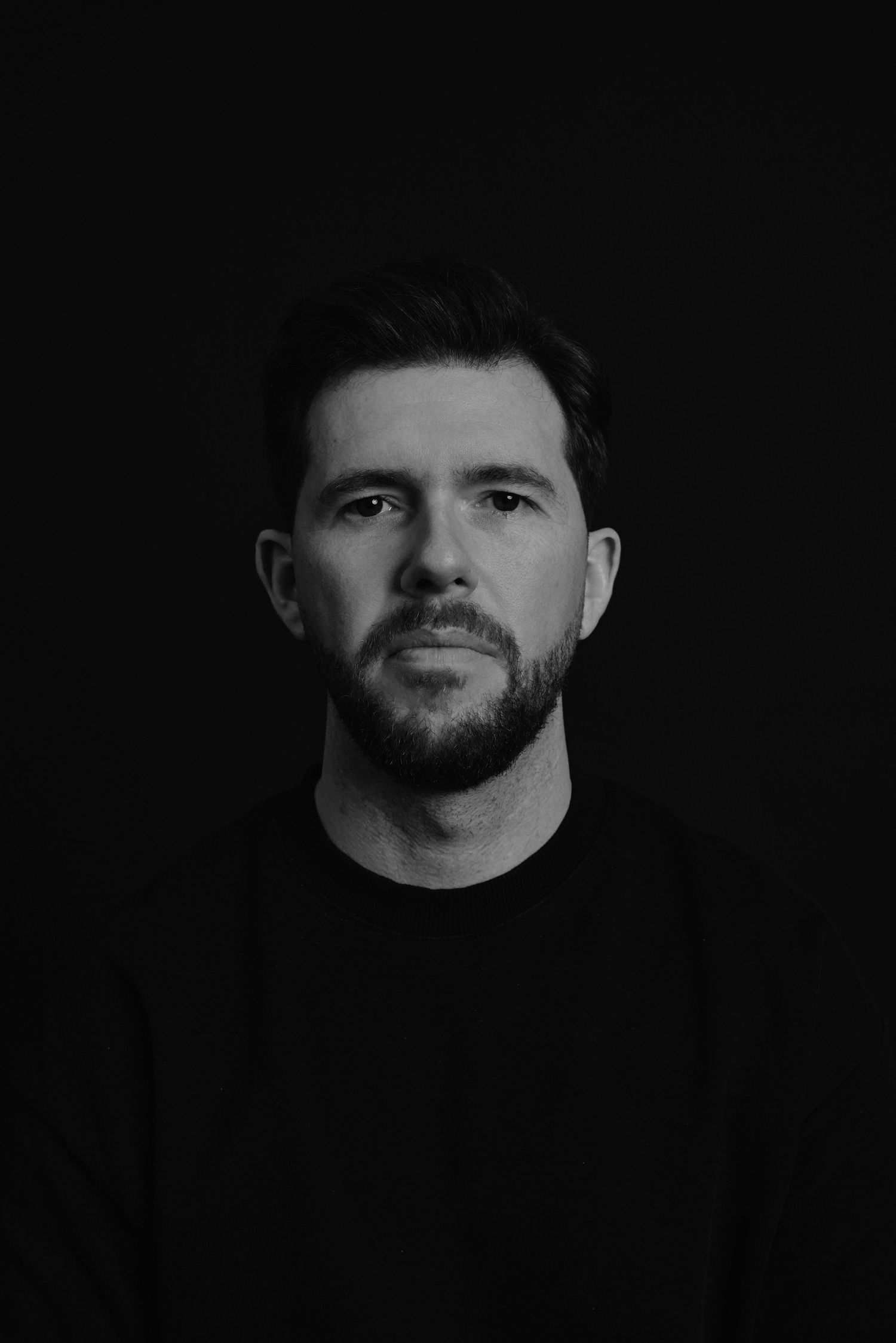 A series of black and white profile portraits showing a person with facial hair against a dark background.