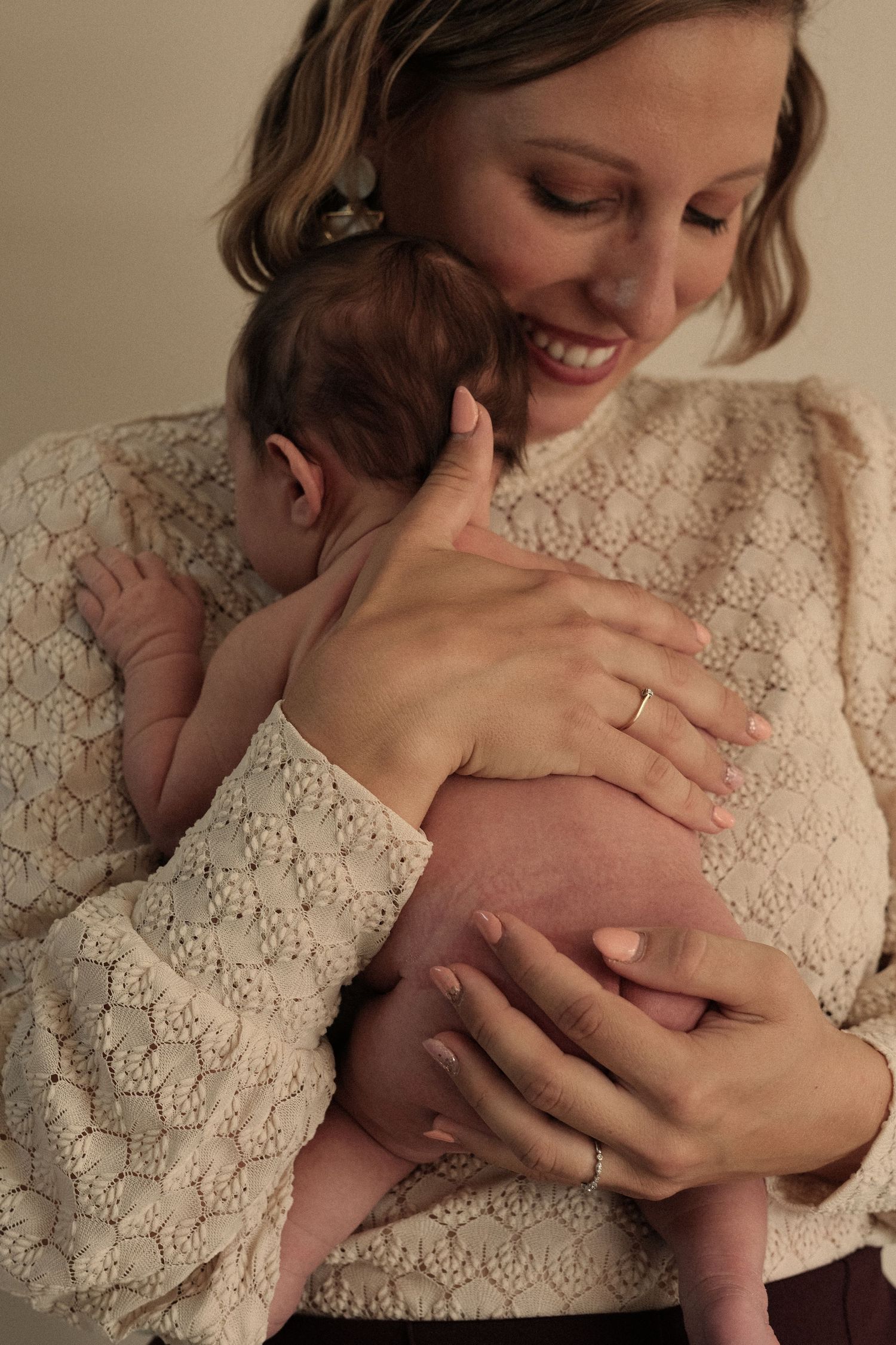 Intimate black and white portraits showing gentle moments between parent and infant.
