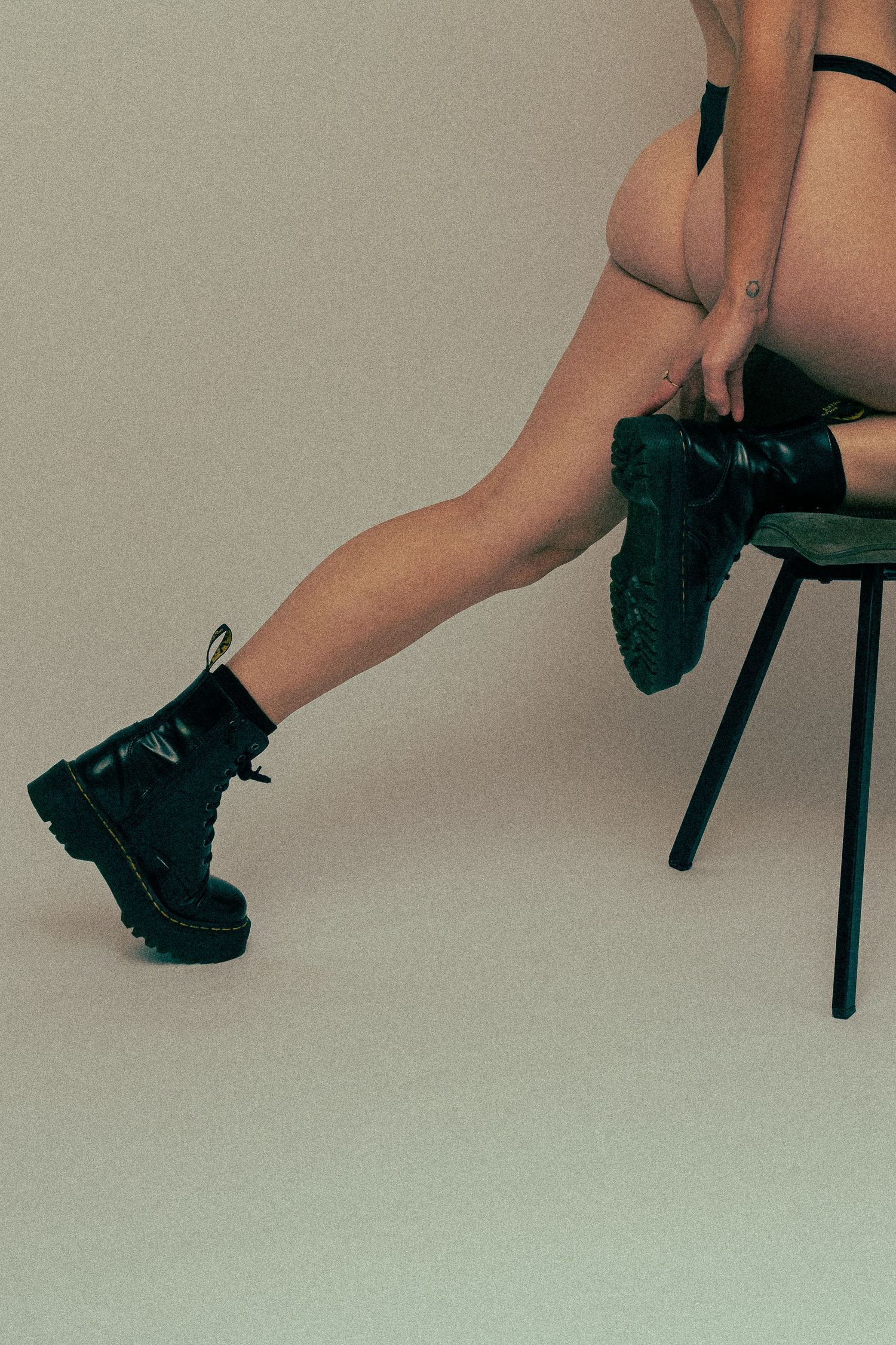 Close-up series of black boots and legs against neutral background.