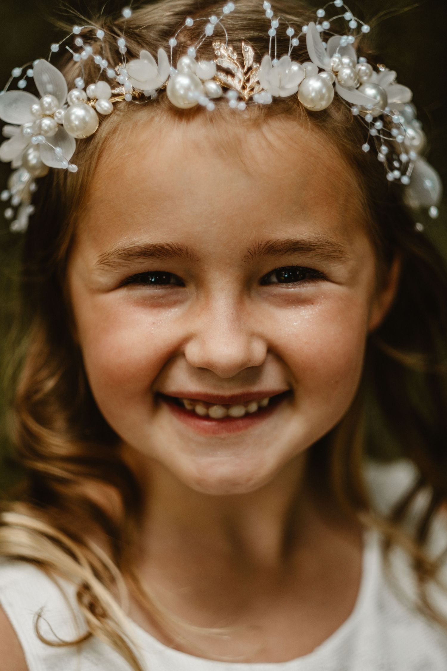 Close-up portrait series showing delicate floral crown with white flowers and pearls.