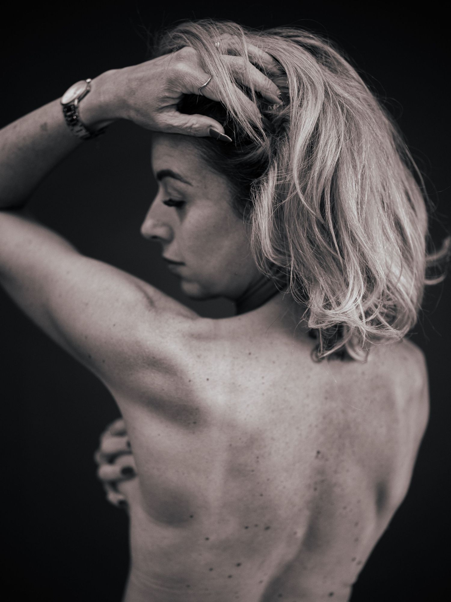 Black and white artistic nude study showing graceful back poses and natural lighting.