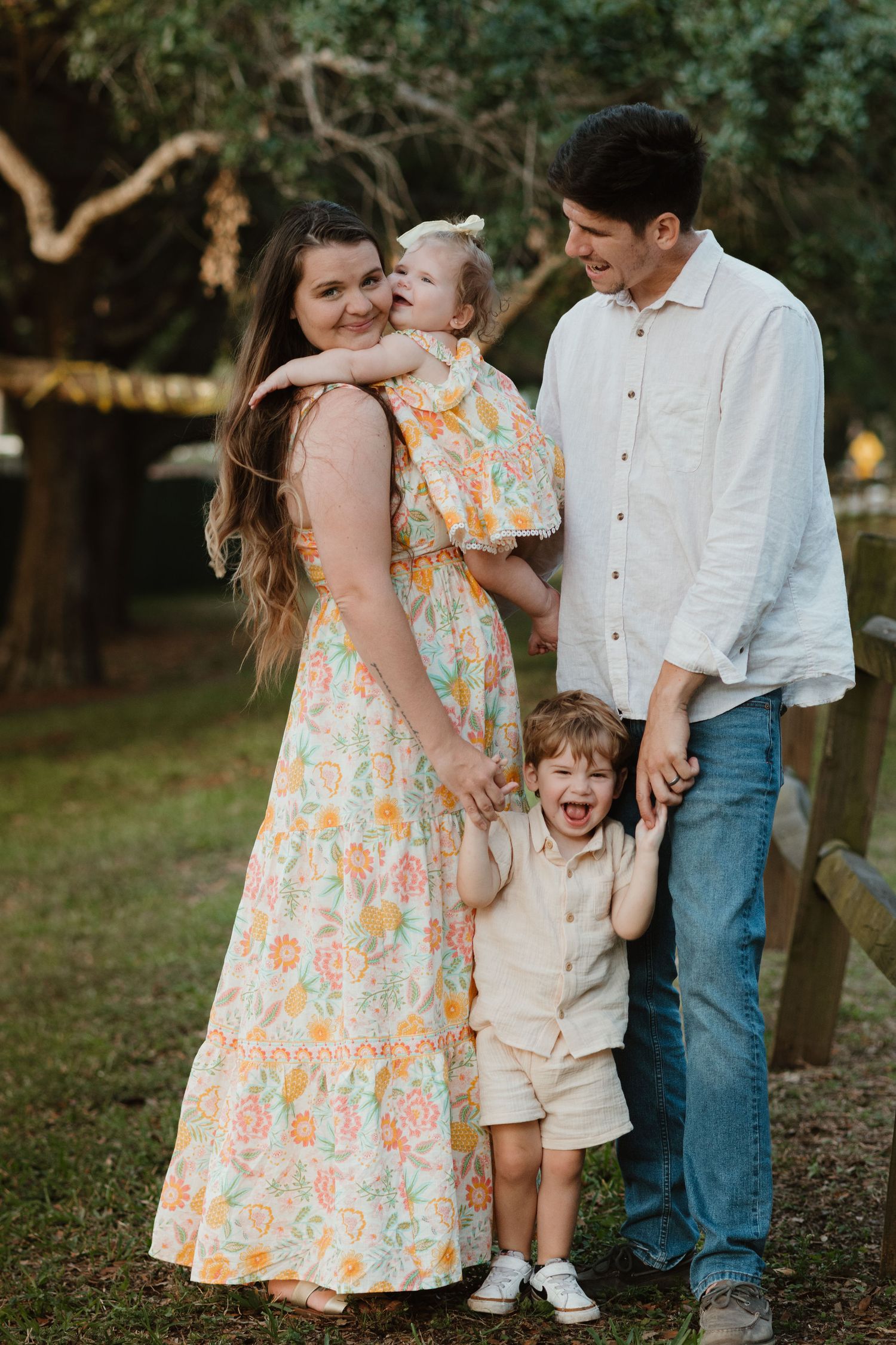 Family enjoying candid moments together in a natural outdoor setting.